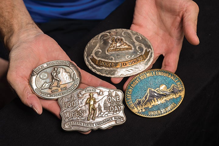 Runner Tom Green displays belt buckles from his 1986 Grand Slam of Ultrarunning